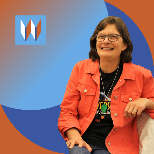 Shelly, Our Tekoa Branch Manager, Poses In Front Of Two Blue Circles On An Orange Backdrop.