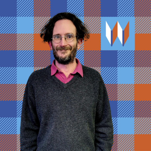 Jackson, Our Albion Branch Manager, Poses In Front Of A Special Orange And Blue Plaid.