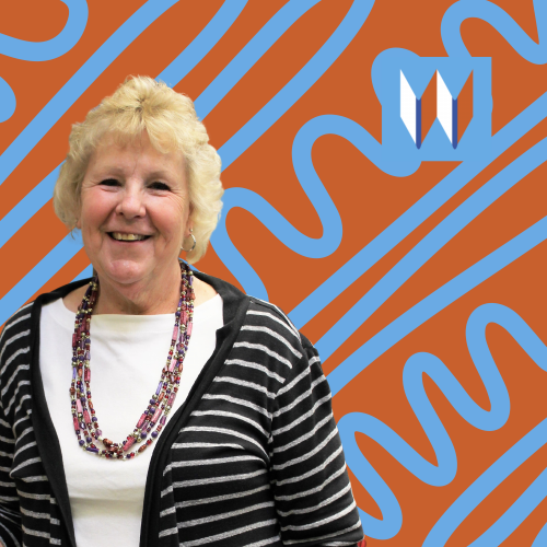Rita, Our Farmington Branch Manager, Poses In Front Of An Orange Background With Blue Doodles.